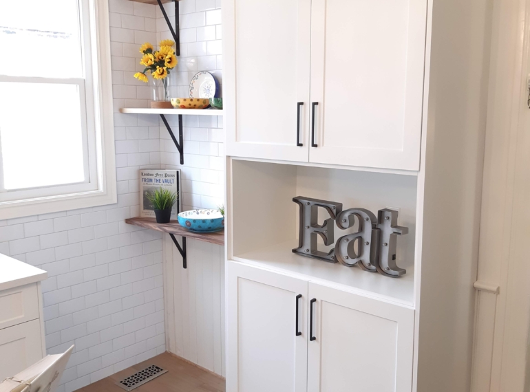 Photo of a contemporary kitchen renovation featuring white cabinetry,