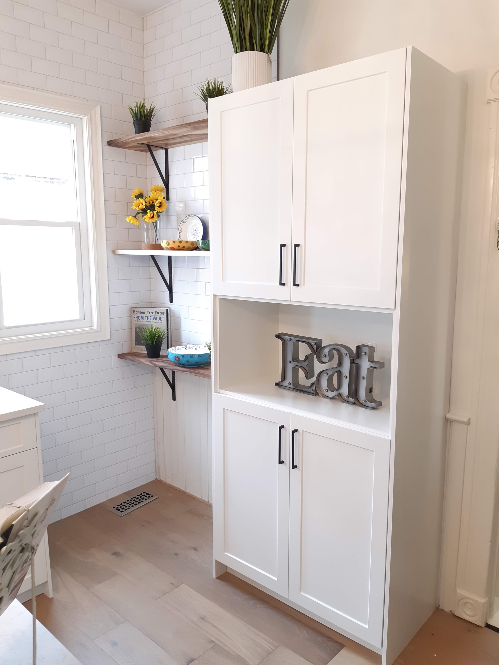 Photo of a contemporary kitchen renovation featuring white cabinetry,